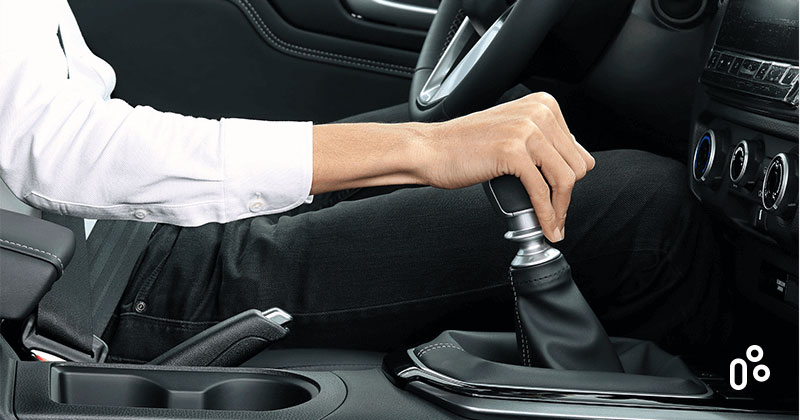 Man holding a gearshift inside a car